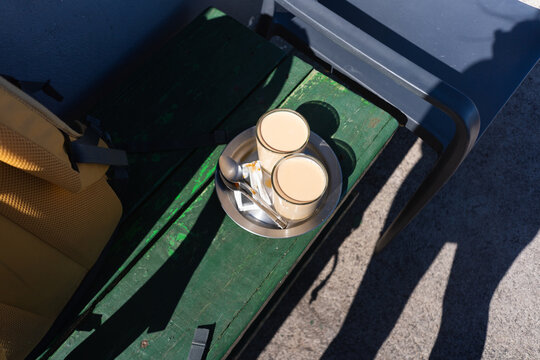 Cafe con leche on outdoor bench