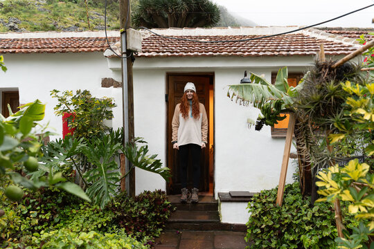 Woman standing doorway rural house Tenerife