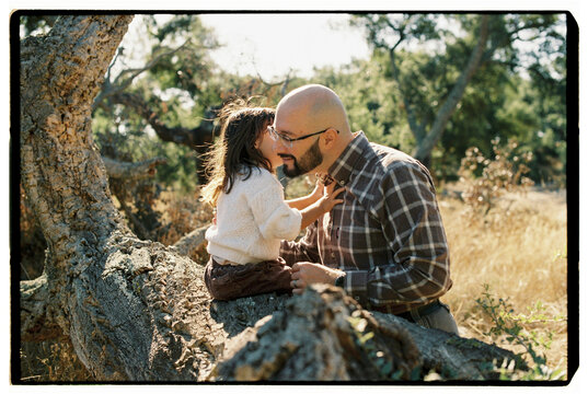 Toddler daughter telling something to her dad