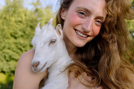 Woman holding goat