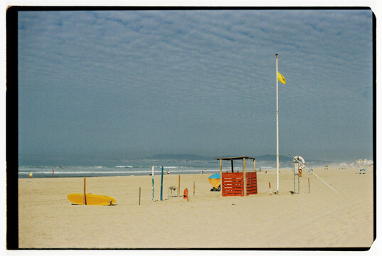 Lifeguard station with yellow warning flag