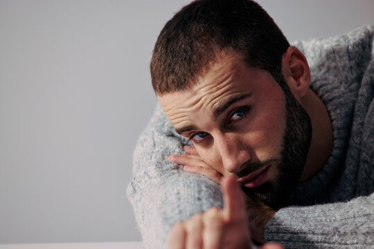 Man With Light Beard Gives a Quiet Gesture in a Simple Setting