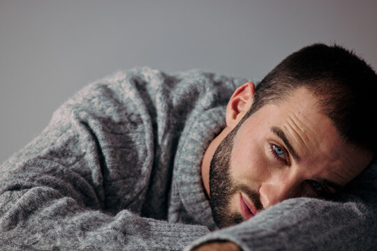 Man Resting on Arm in a Simple Setting During Daytime