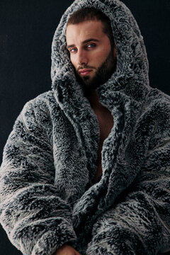 Man in Gray Fur Coat Poses for a Close-Up Shot Indoors
