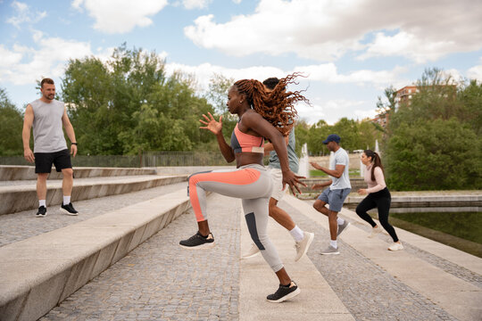 Group exercise on outdoor stairs in urban park