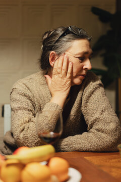 Mature woman by kitchen table portrait