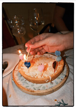 Birthday cake with heart candles in intimate evening setting