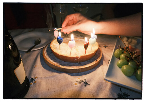 Birthday cake with candles on cozy dinner table