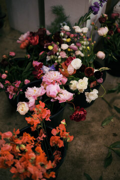 close up of buckets filled with harvested flowers in florist studio