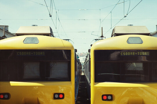 Two Yellow Commuter Trains