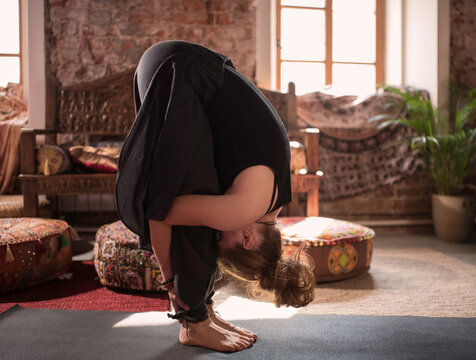Woman doing Standing Forward Bend pose