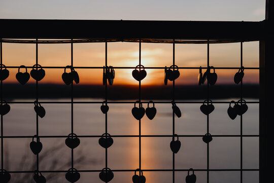 Heart Love Locks Silhouette on Fence at Sunset
