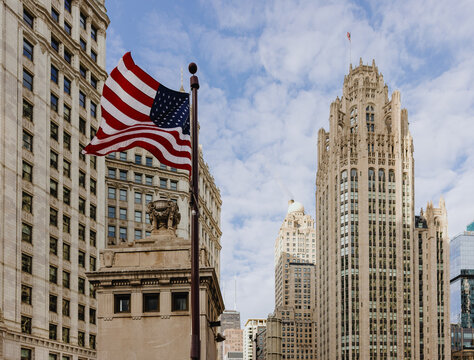 American Flag Waving on a Building in Chicago City Skyline