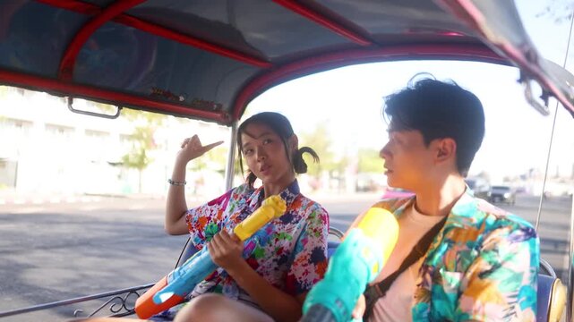 Young Couple Celebrating Songkran Festival in a Bangkok Tuk Tuk