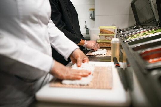 Sushi Chefs Preparing Rice in Commercial Kitchen