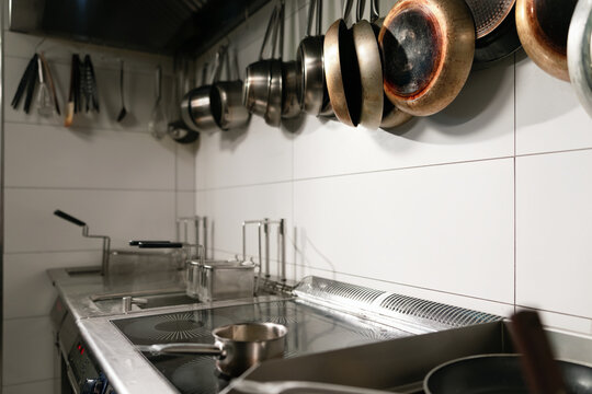 Commercial Kitchen Stove With Hanging Pans and Cookware