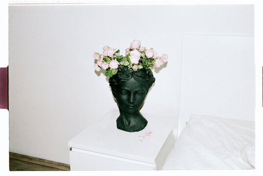 TITLE:
Dark Bust Sculpture Vase With Pink Roses on White Dresser 