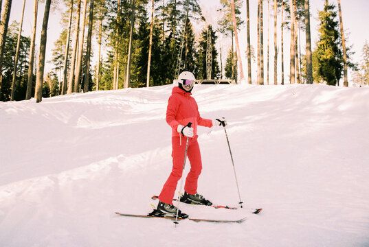 Film Photo of a Skier in Red Suit on a Sunny Winter Slope