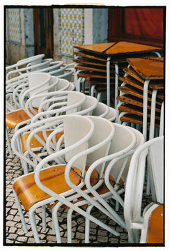 Stacked cafe chairs and tables in Lisbon