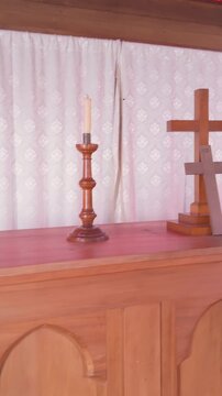 An antique organ with sheet music sits in a wooden chapel in Whangamomona, Manawatu-Whanganui, New Zealand.