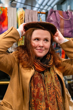 woman trying on stylish beret hat