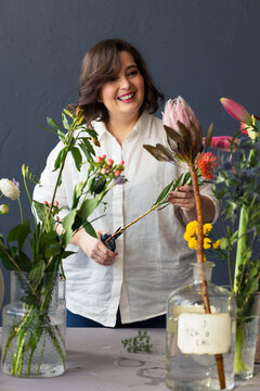 Smiling Florist Woman Arranging Colorful Flower Bouquet