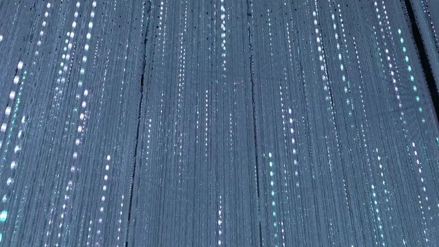 Abstract texture background featuring vertical stripe pattern with glowing light dot point creating minimalist aesthetic, elegant serene blue geometric wallpaper design, modern monochromatic dark