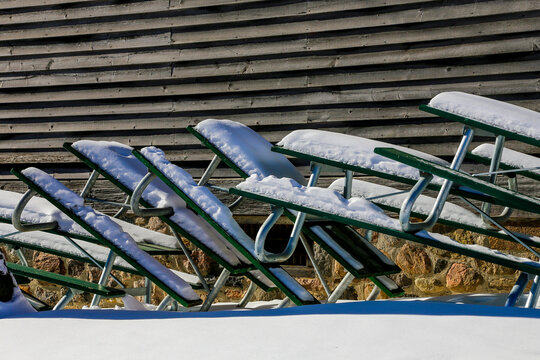 picnic tables in winter covered with snow