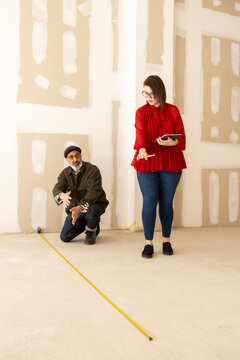 Interior designer and architect taking measurements 