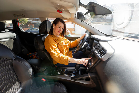woman inside car setting up gps
