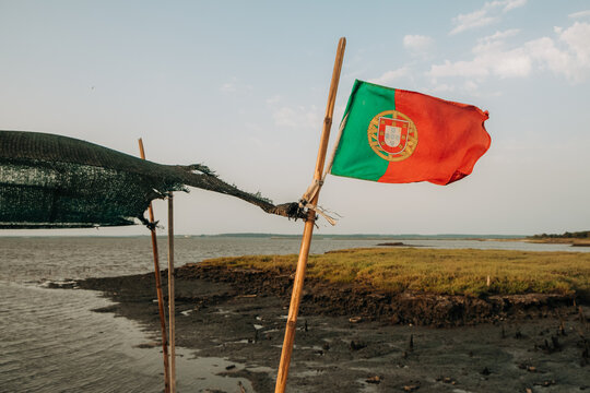 Portuguese Flag Over Coastal Estuary