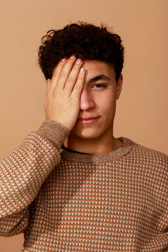 Teenager Covering One Eye With Hand