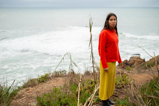 Indigenous woman walking by the sea