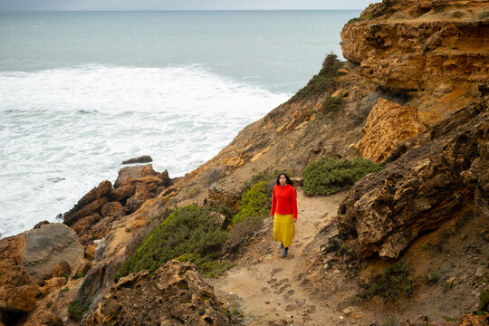 Indigenous woman walking by the sea