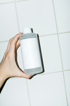 Mockup beauty product bottle with space for text or design & tile wall
