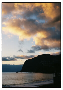 Golden sunset over Madeira cliffs and Atlantic Ocean