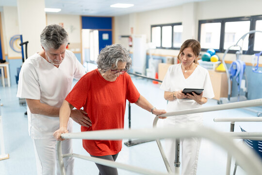 Senior patient doing physical therapy with physiotherapists