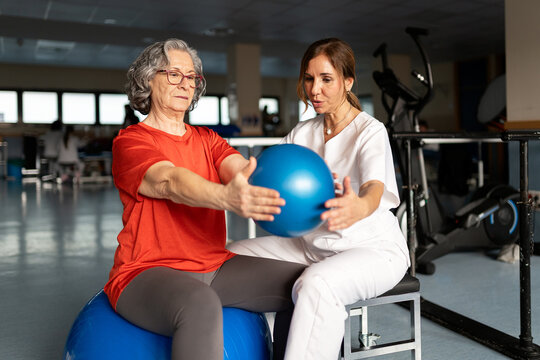 Senior woman doing physical therapy with physiotherapist