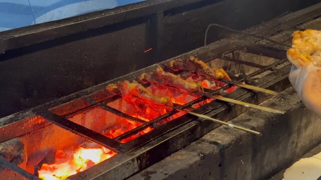 Tengkleng cooking, Sate Buntel Close-up of cooking process using traditional stove. Spicy Tengkleng or Tongseng - Indonesian food, Sate Buntel Solo
