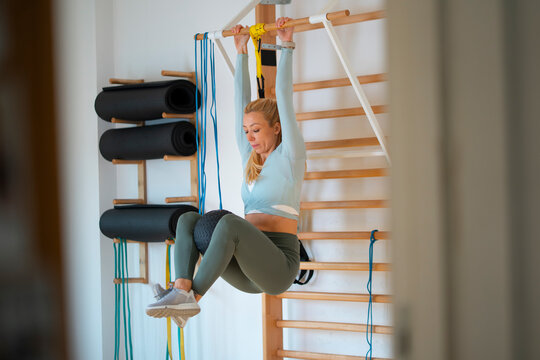 Woman exercises on fitness equipment indoors