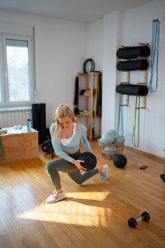Woman exercises with a ball in a fitness studio
