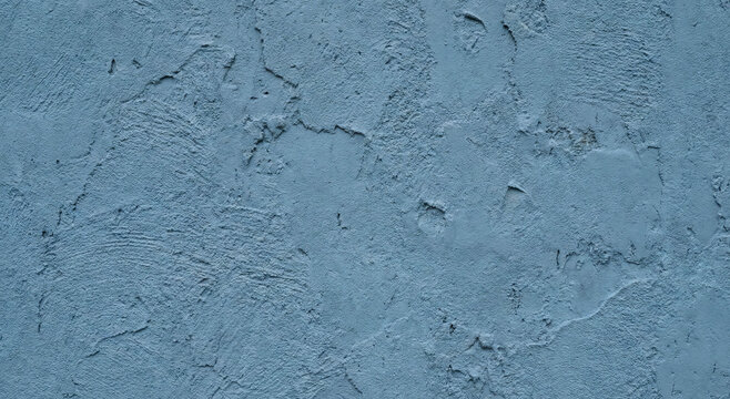 Close-up of a textured blue concrete surface, showcasing an even distribution of roughness and subtle variations in color and pattern, ideal for backgrounds.