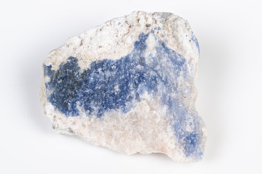 Striking azure mineral vein on crystalline white quartz background. Magnificent blue chrysocolla streak contrasting with rough crystalline matrix and granular surface textures