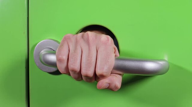Closeup Hand Gripping Bright Green Door Handle in a Film Style Shot.