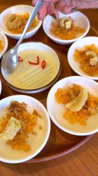 Adding Fish Sauce to Vietnamese Banh Beo Steamed Rice Cakes