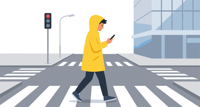 Person wearing yellow raincoat crossing street while using phone at intersection