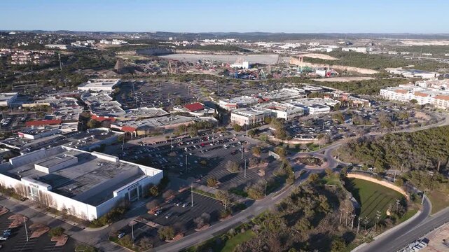 La Cantera and Six Flags Fiesta Texas sit close to each other near The Rim in San Antonio, Texas. A drone captures their proximity and showcases the expansive local attractions.