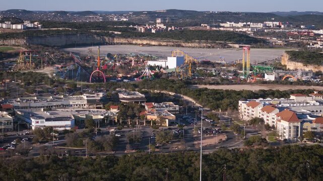 La Cantera and Six Flags Fiesta Texas sit close to each other near The Rim in San Antonio, Texas. A drone captures their proximity and showcases the expansive local attractions.