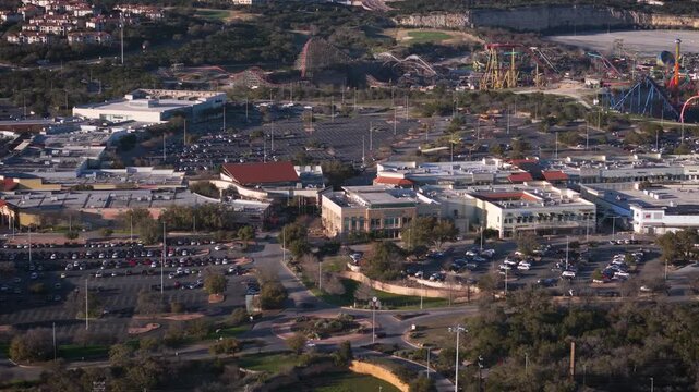 La Cantera and Six Flags Fiesta Texas sit close to each other near The Rim in San Antonio, Texas. A drone captures their proximity and showcases the expansive local attractions.
