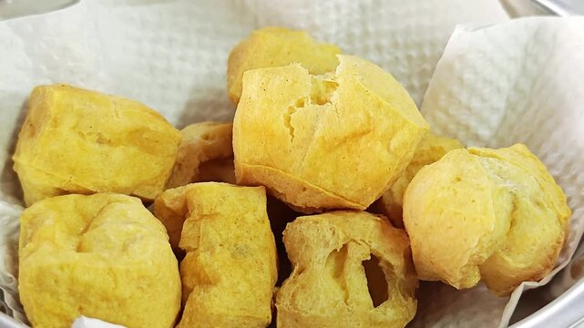 Deep fried tofu cubes with crunchy texture, a popular Asian vegetarian snack.